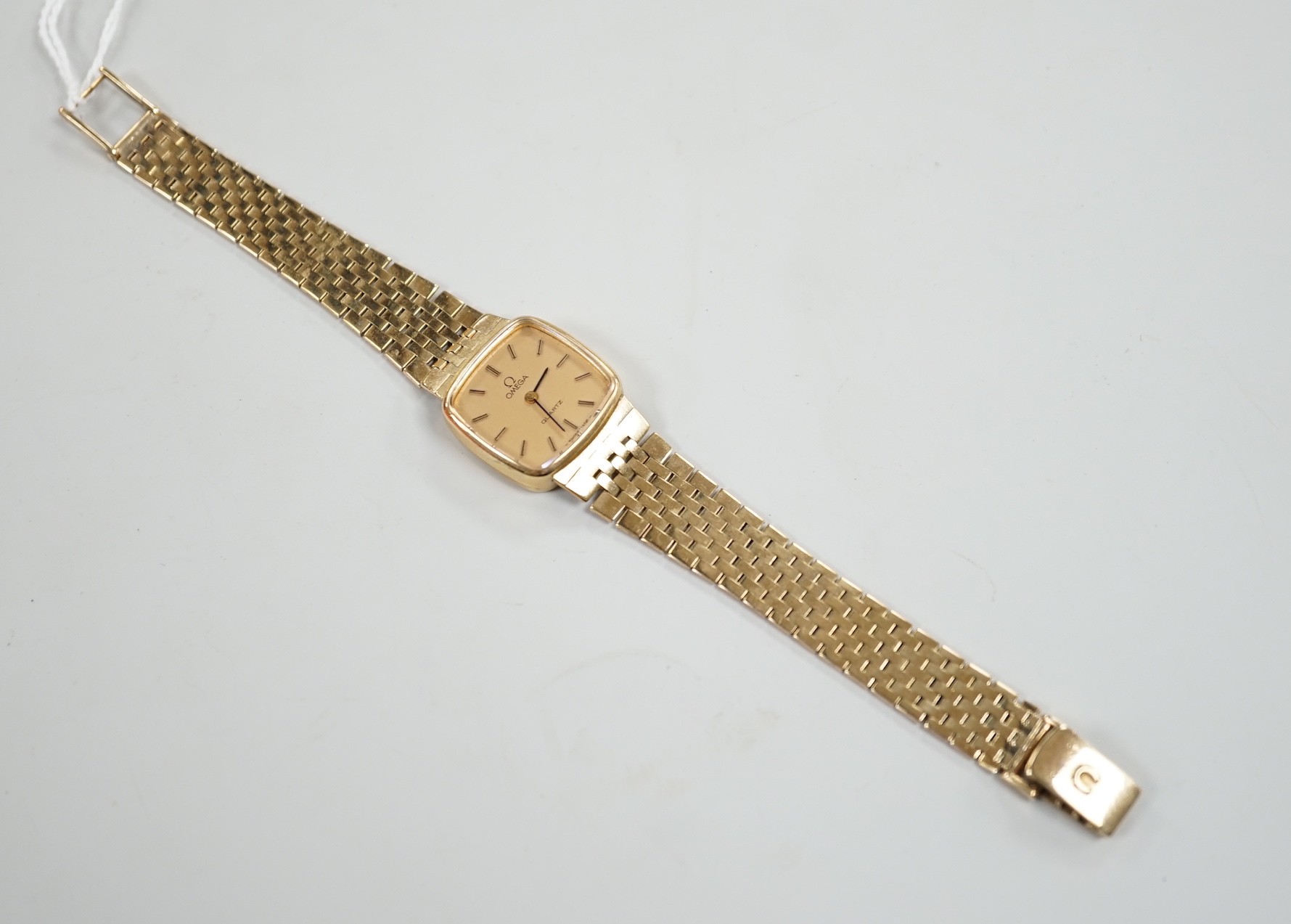 A lady's 9ct gold Omega quartz wrist watch, on a 9ct gold Omega bracelet, overall 17.3cm, gross weight 29 grams, with Omega box and booklet.